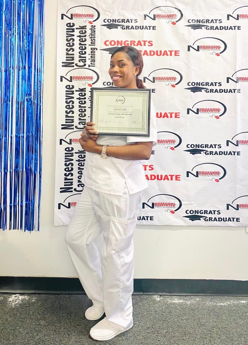Proud graduate with certificate at the nCareerTek banner